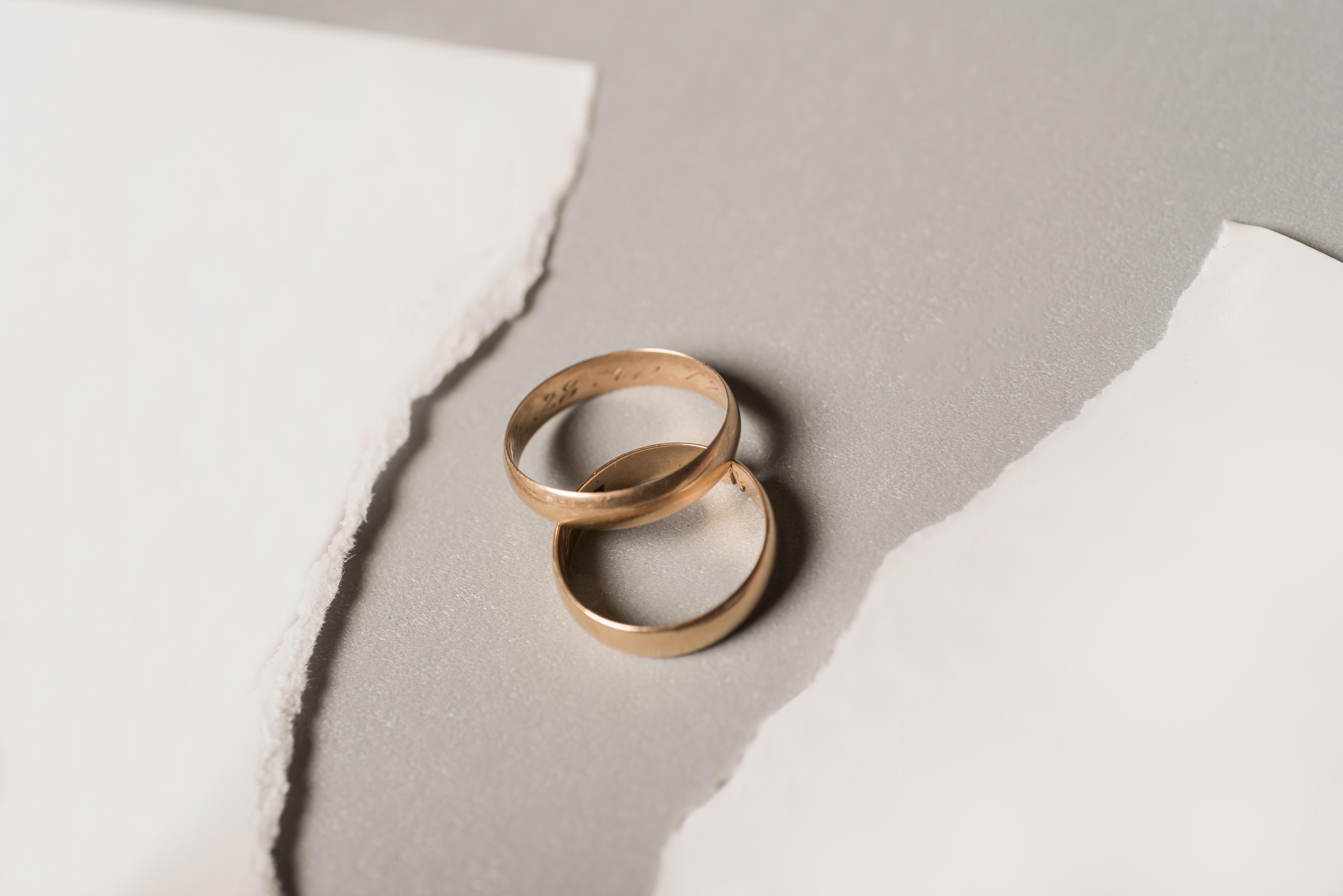 broken-paper-with-golden-wedding-rings